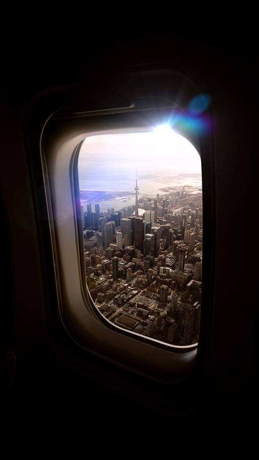 An Aerial City View From A Plane Window Wallpaper