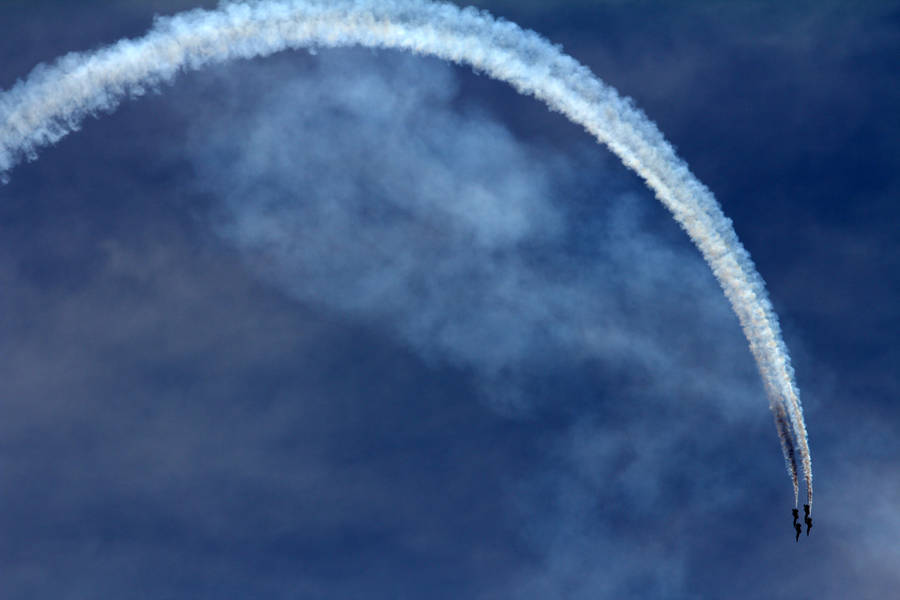An Aerial Display Of Aerobatic Stunts By An Airplane Wallpaper