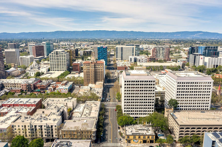 An Aerial View Of A City With Tall Buildings And Trees Wallpaper