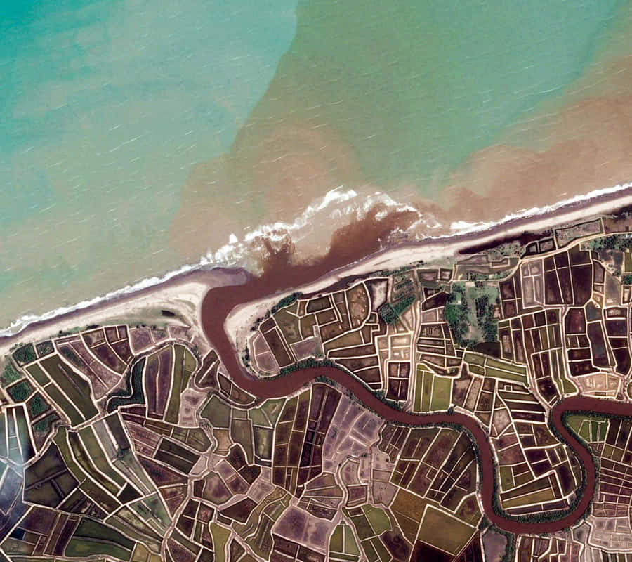 An Aerial View Of A River And Land Wallpaper