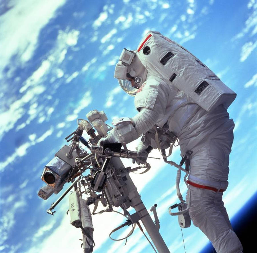 An Astronaut In Space Working Hard Wallpaper