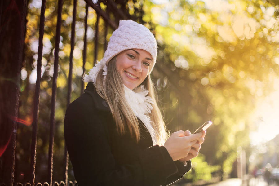 An Autumn Phone Nestled In A Bed Of Fallen Autumn Leaves Wallpaper