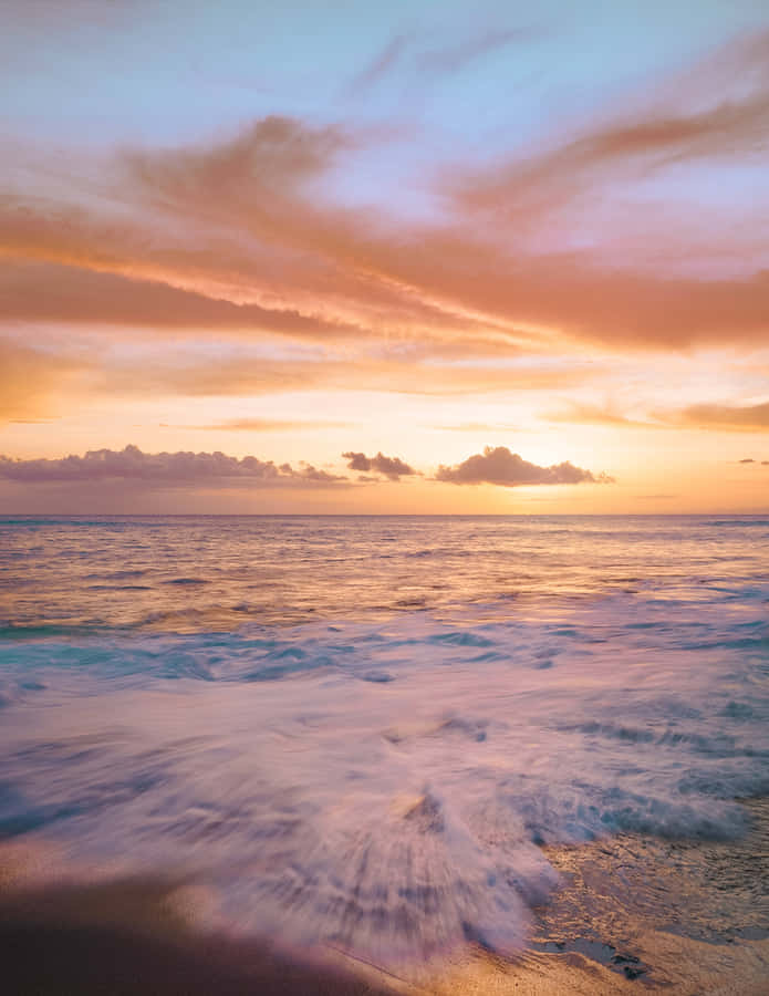 An Idyllic Beach Sky Balances The Blues And Creams Of A Peaceful Day Wallpaper