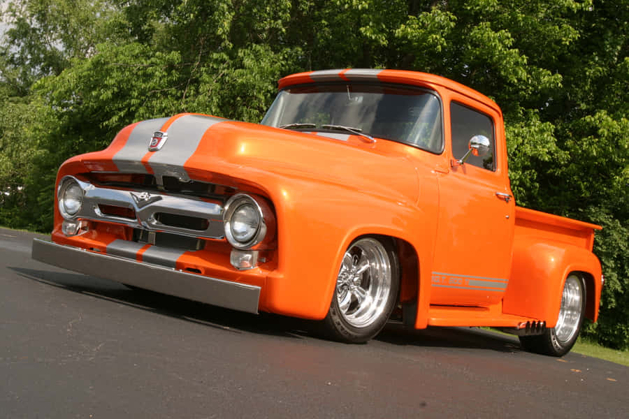 An Orange Truck Is Parked In The Parking Lot Wallpaper