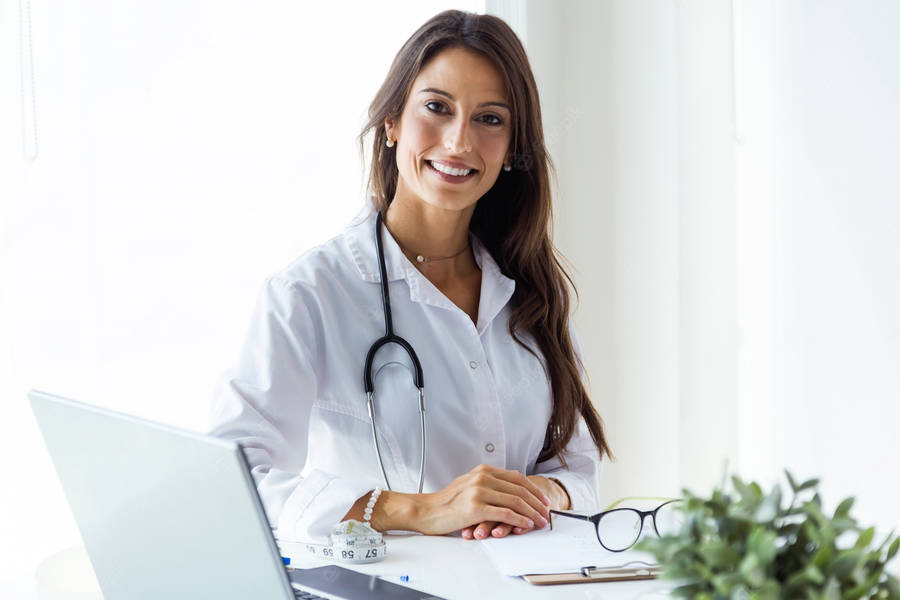 Angelic Physician On Her Desk Wallpaper