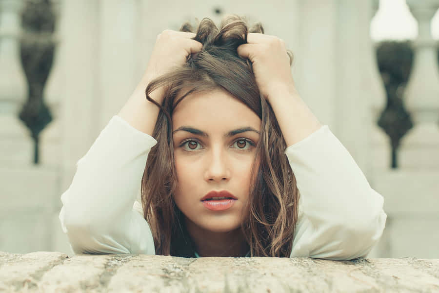 Anxious Woman Clutching Hair Wallpaper