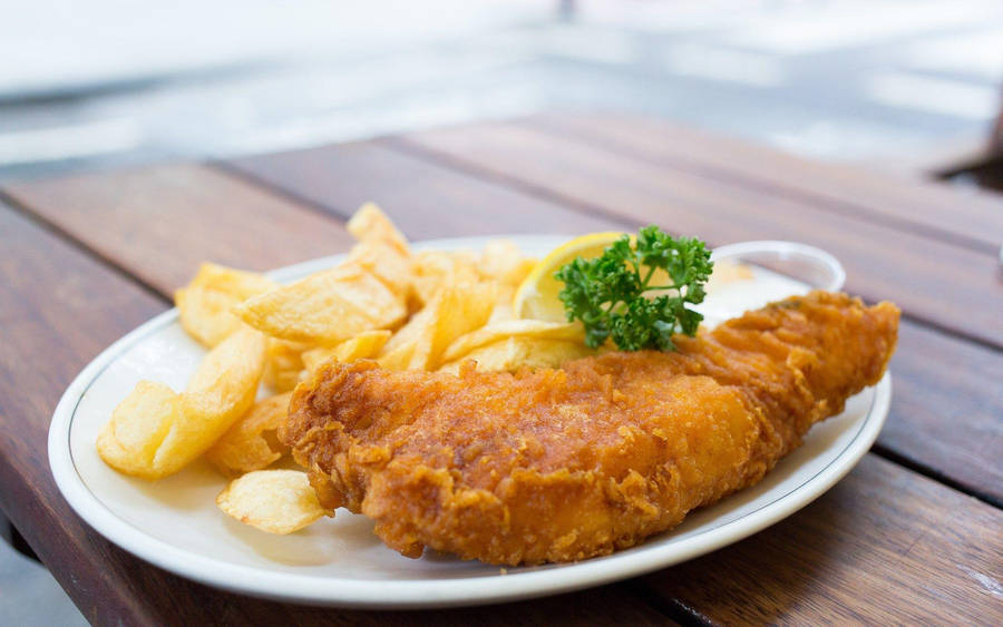 Appetizing Plate Of British Fish And Chips Wallpaper