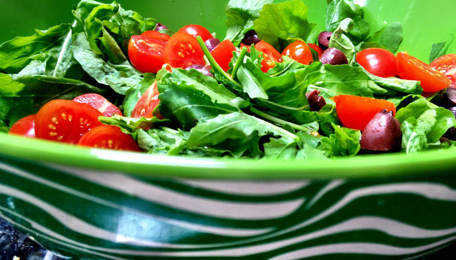 Arugula And Tomato Salad In Green Bowl Wallpaper