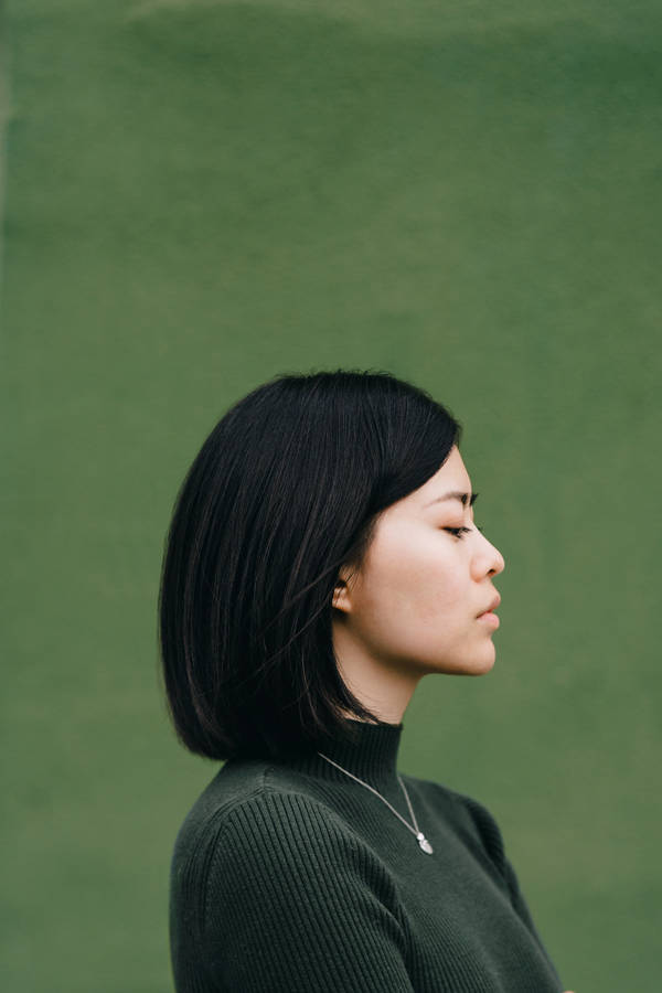 Asian Woman In Dark Green Turtleneck Wallpaper