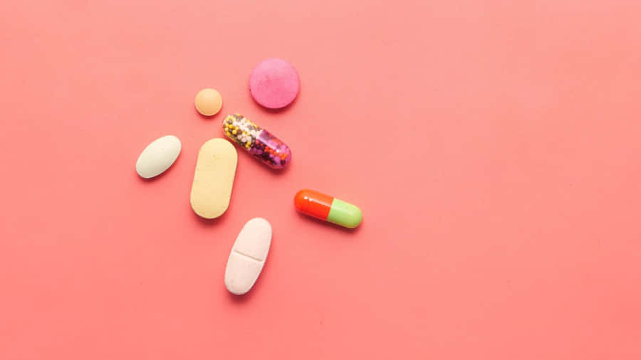 Assorted Medications Pink Background Wallpaper