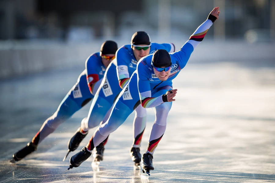 Athlete Embracing Triumph In Olympics Wallpaper