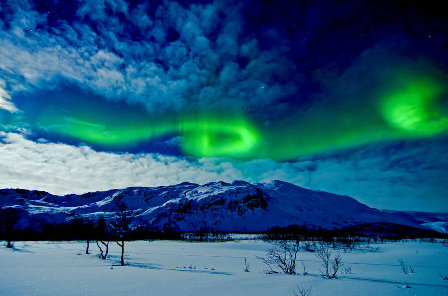 Aurora Borealis Above Snow Mountains Wallpaper