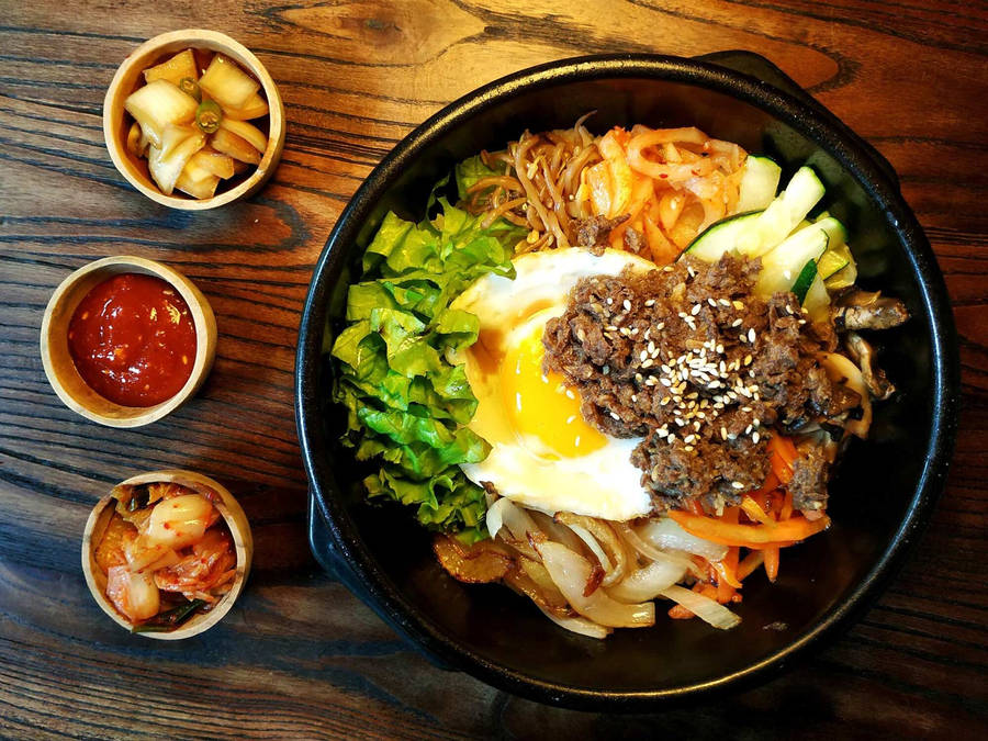 Authentic Korean Bibimbap Dish Served With Side Dishes Wallpaper