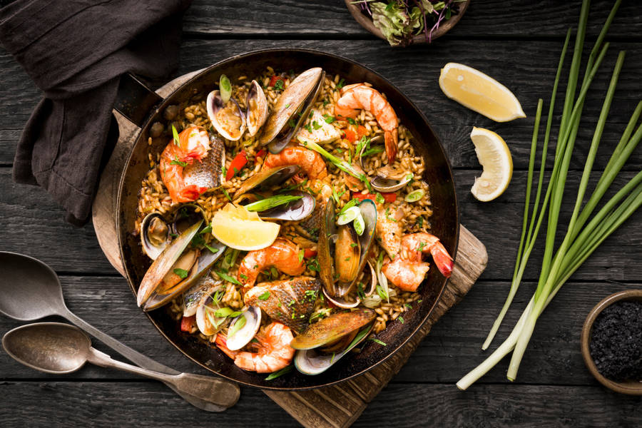 Authentic Spanish Seafood Paella In A Traditional Paella Pan Wallpaper