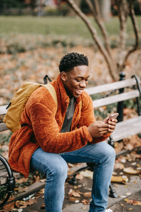 Autumn Phone Man In Orange Jacket Wallpaper