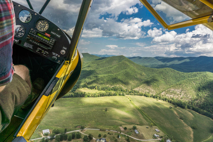 Aviation Airplane Flying Over Scenic Landscape Wallpaper