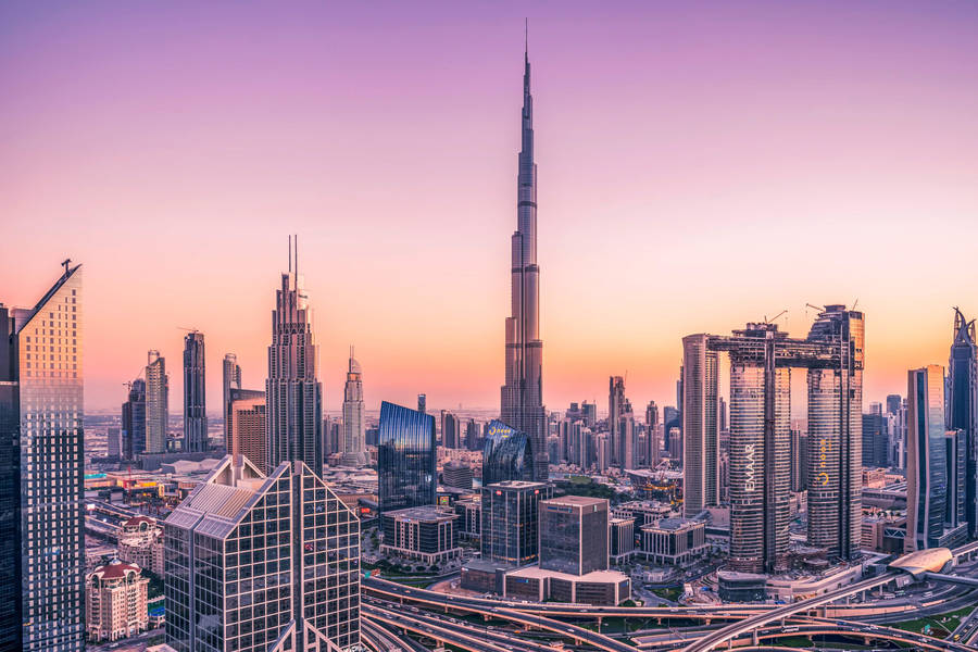 Awe-inspiring Sunrise Over Futuristic Dubai Skyline In 4k Resolution Wallpaper