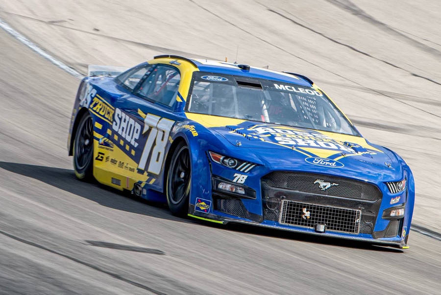 B.j. Mcleod Driving His Blue And Yellow Racing Car Wallpaper