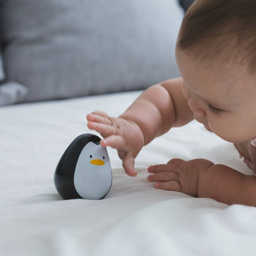 Baby And A Baby Penguin Toy Wallpaper