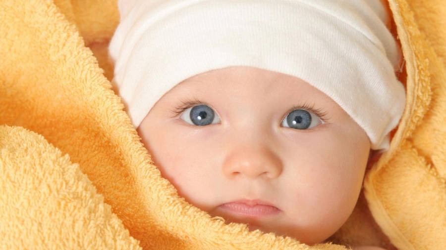 Baby Boy Wrapped In Yellow Towel Wallpaper