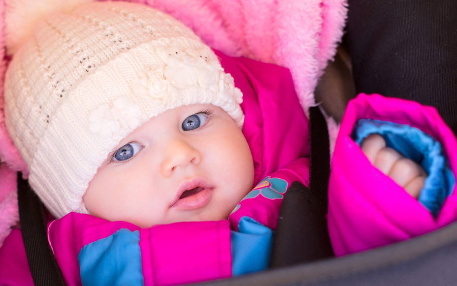 Baby On Pink Bonnet Wallpaper