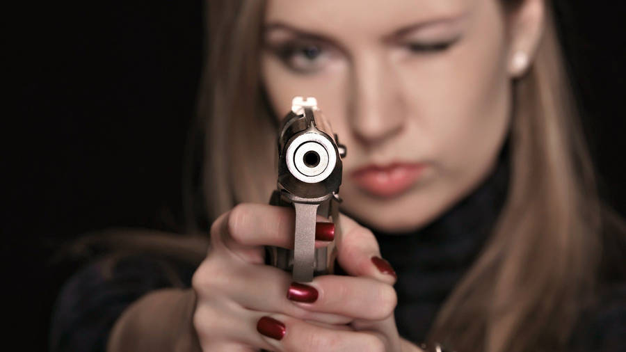 Bad Girl Pointing A Gun Wallpaper