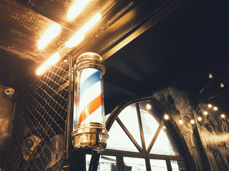 Barber Pole Under Yellow Lights Wallpaper