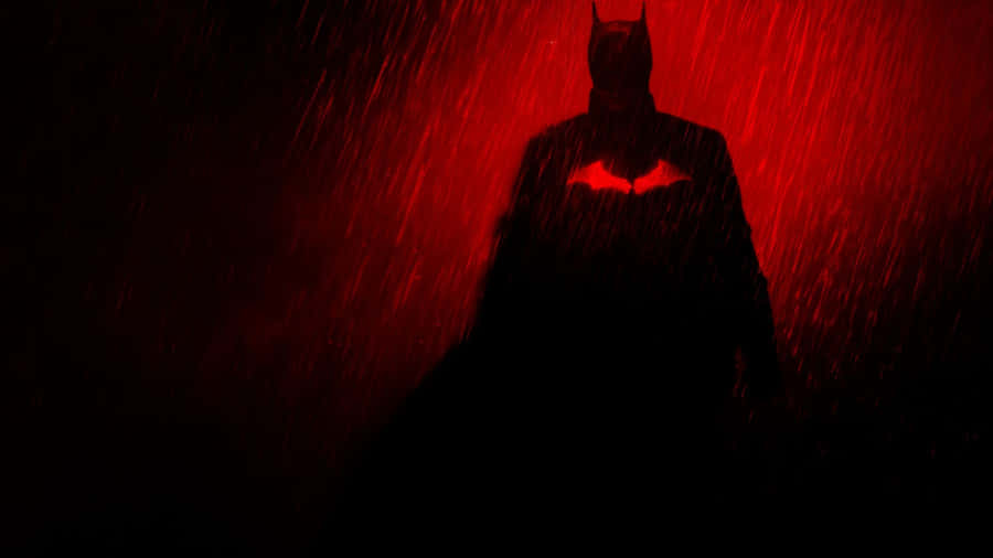 Batman Standing On The Edge Of A Skyscraper Wallpaper