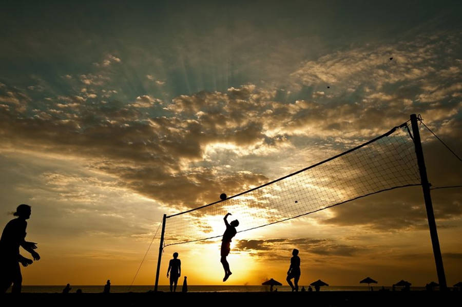 Beach Volleyball Silhouette On A Cloudy Day Wallpaper