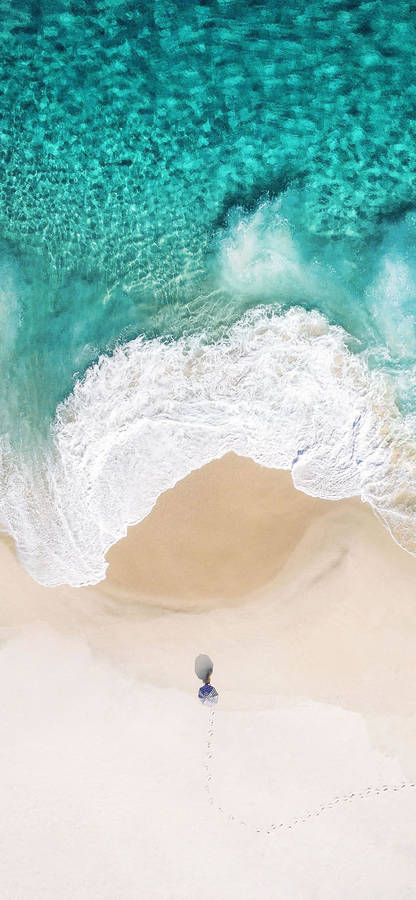 Beachfront View With Bright Blue Sky And Ocean Waves Wallpaper