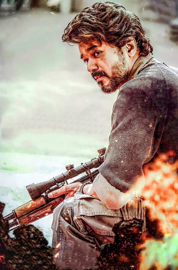 Beast Vijay Kneeling With Gun Wallpaper