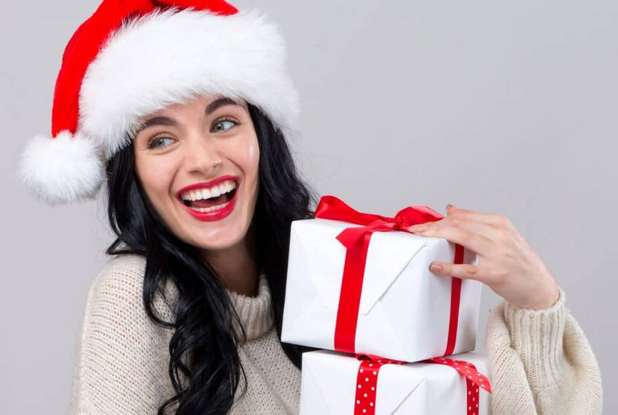 Beautiful Girl Holding Christmas Presents Wallpaper