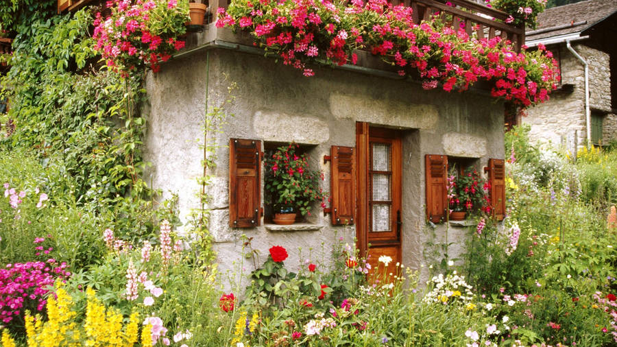 Beautiful House With Flowers Around Wallpaper