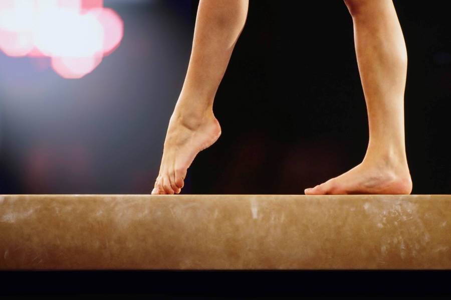 Beginner Gymnastics Exercise On Balance Beam Wallpaper