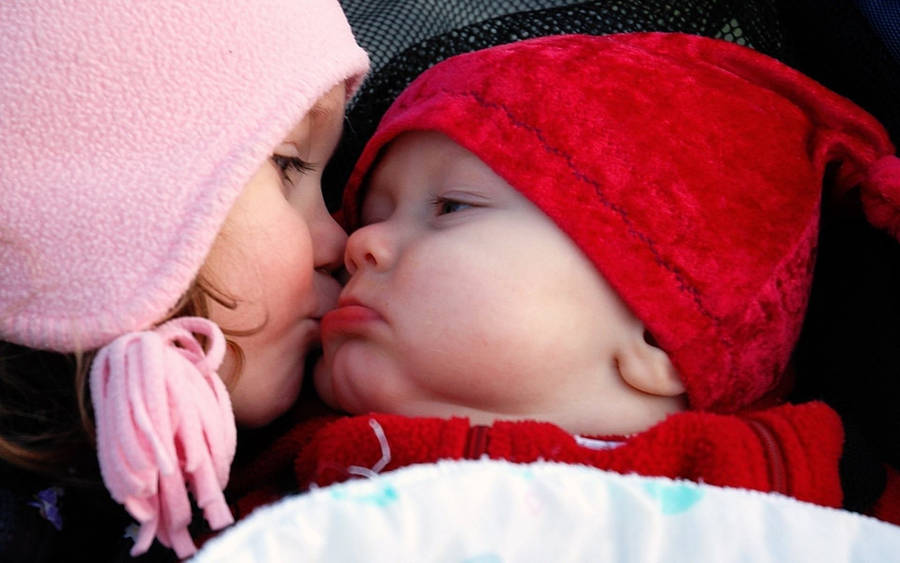 Big Sister Kissing Baby Boy Wallpaper