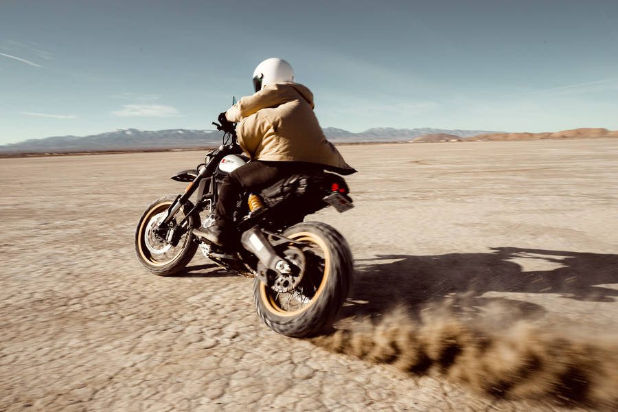 Bike Rider Creating Dust Clouds Wallpaper