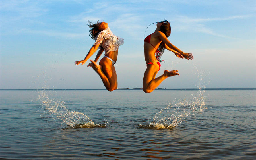 Bikini Girl Jumping On Sea Wallpaper