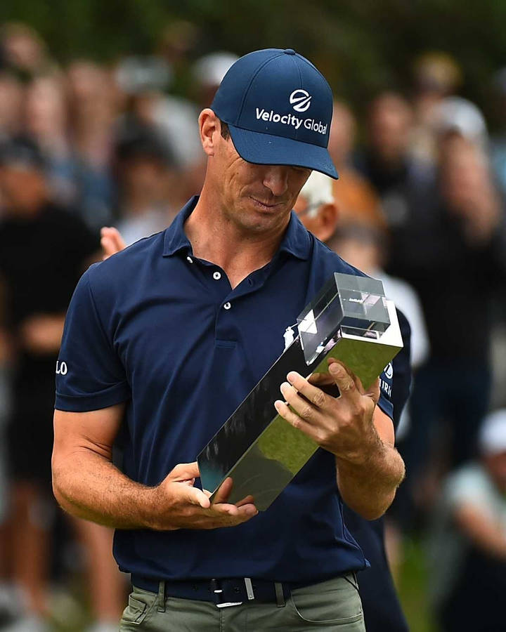 Billy Horschel Looking At His Trophy Wallpaper