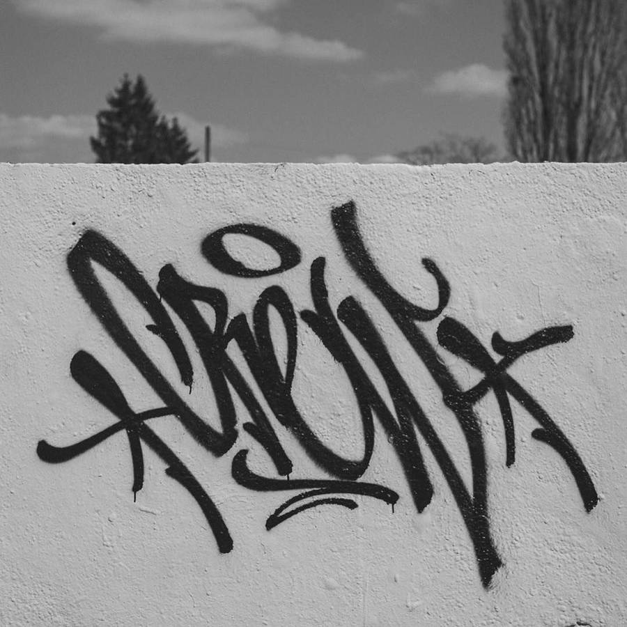 Black And White Graffiti Tag On A Wall Fence Wallpaper