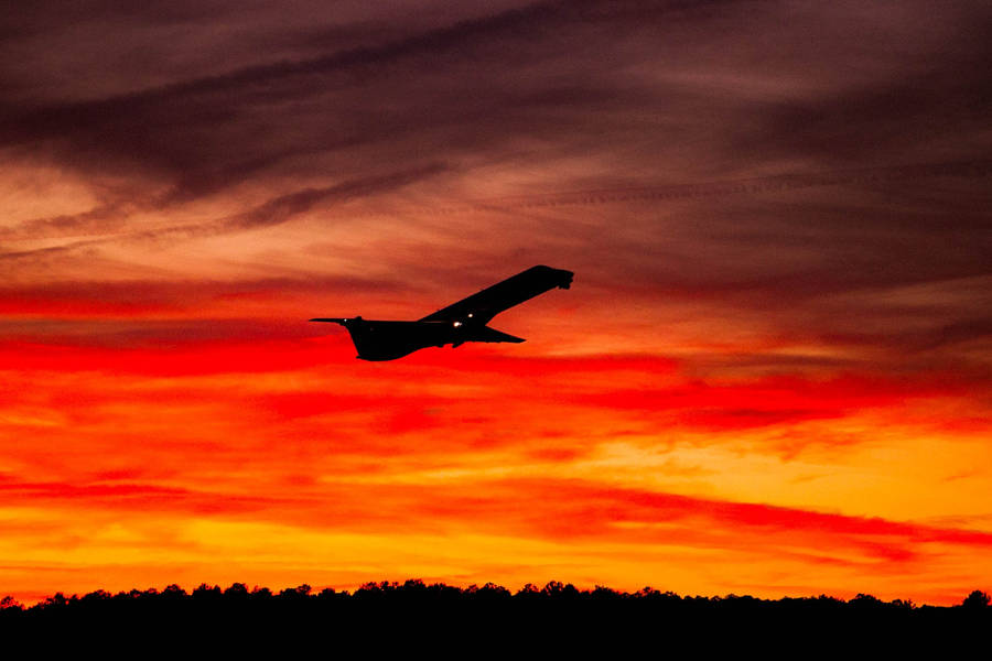 Black And White Jet Soaring Through The Skies Wallpaper