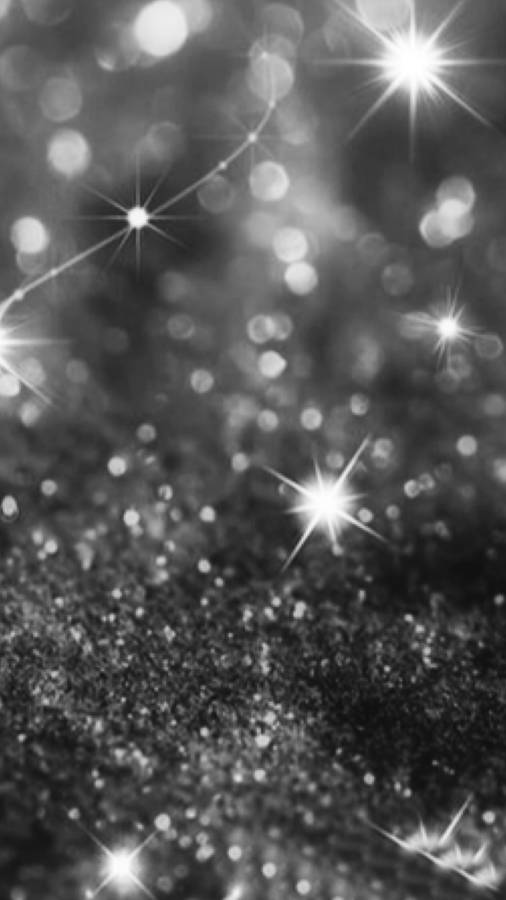 Black Glitter Bokeh And Star Rays Wallpaper