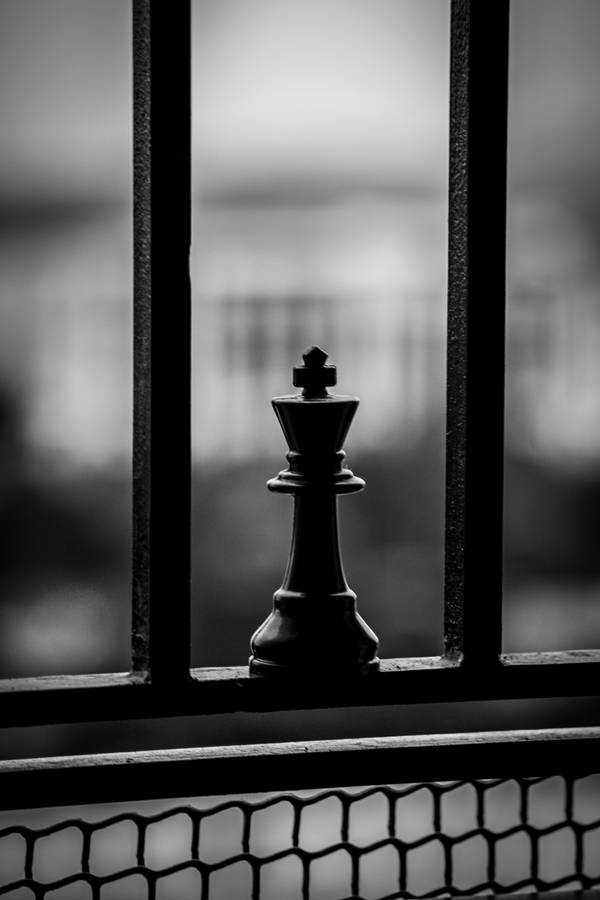 Black King Chess Piece On A Railing Wallpaper