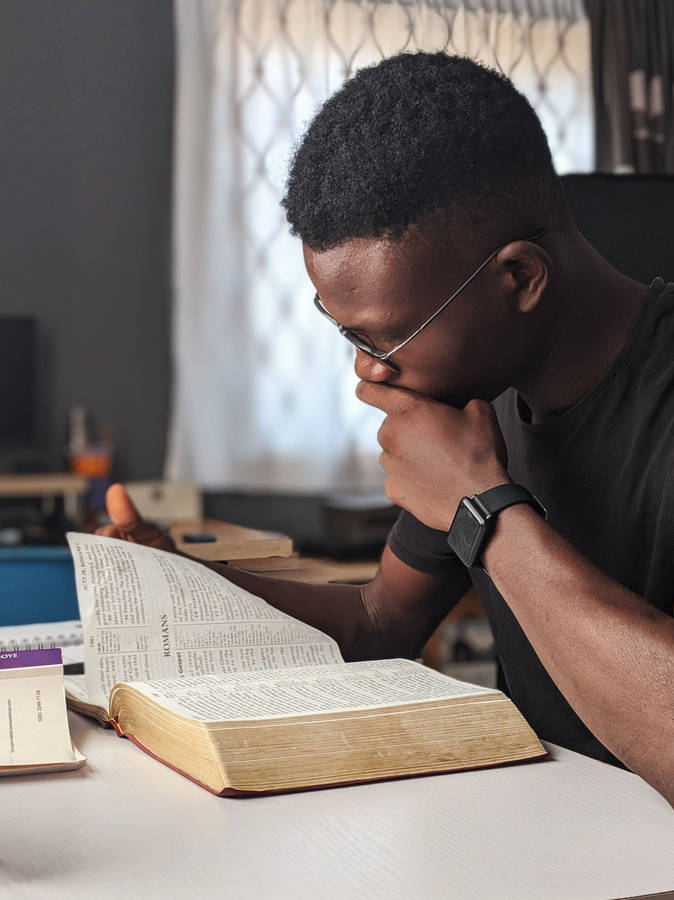 Black Man Focus On His Book Wallpaper