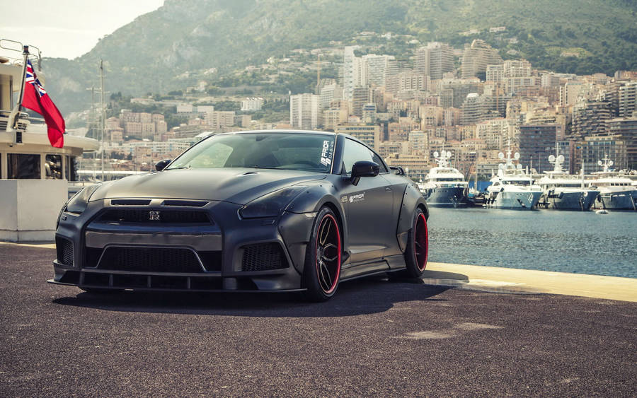 Black Nissan Gtr Car In Front Of Ocean Wallpaper