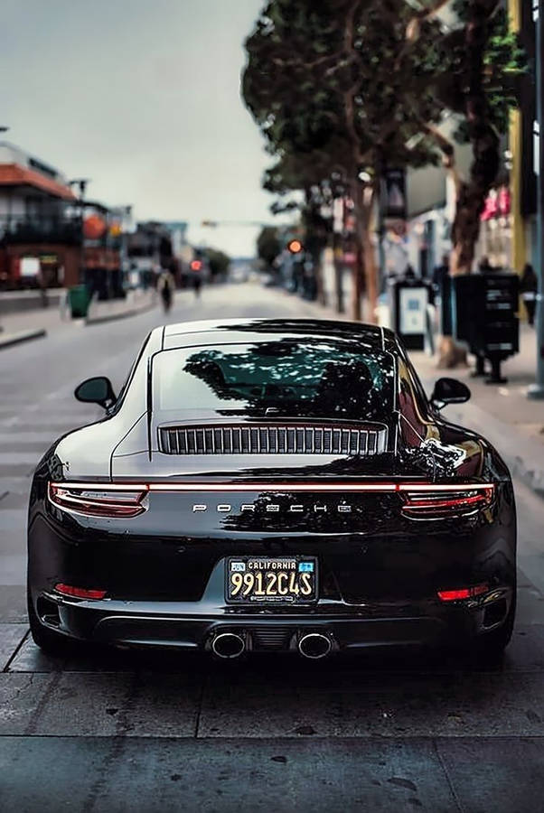 Black Porsche 911 Driving Around Town Wallpaper