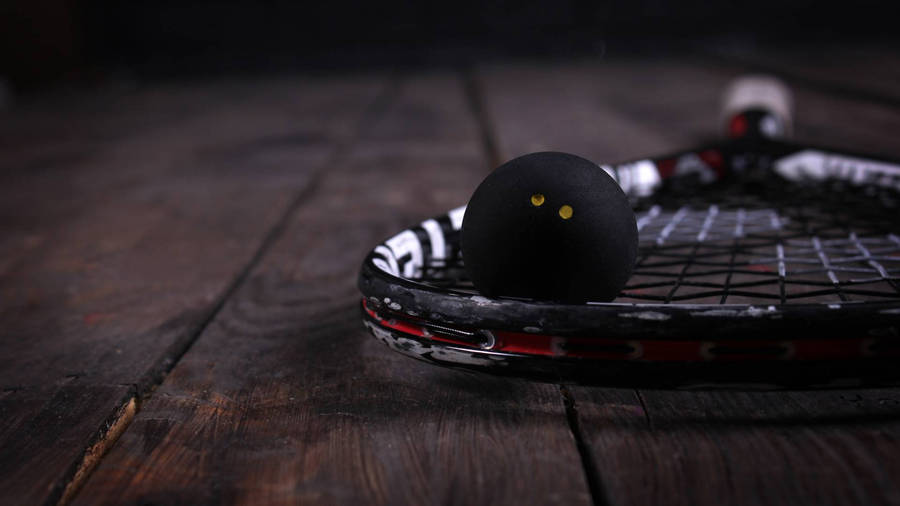 Black Squash Racket And Ball Wallpaper