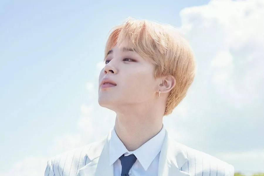 Blonde Jimin Of Bts Tilting His Head Wallpaper