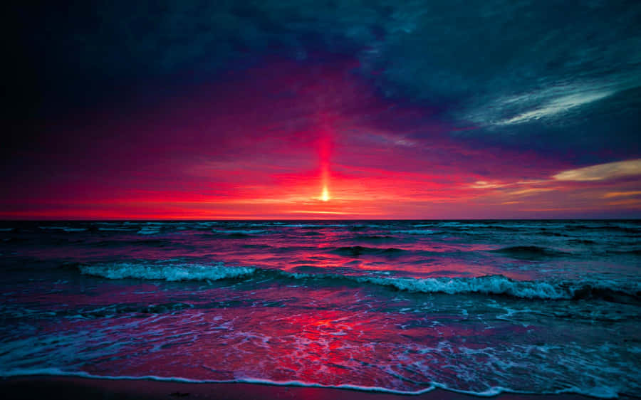 Blue And Purple Sunset With A Red Sun Wallpaper