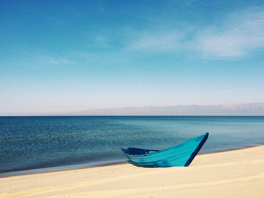 Blue Boat On Calm Blue Ocean Wallpaper