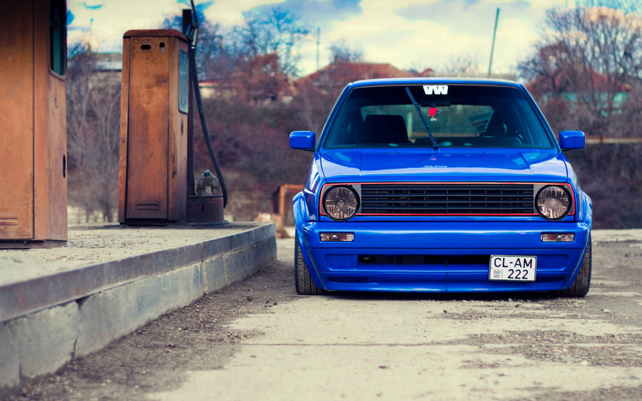 Blue Car In Gas Station Wallpaper